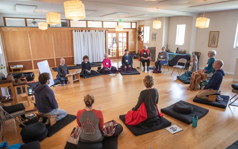 students in circle on mats in wood floor classroom @ mindfulness northwest bellingham wa