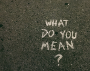 "What do you mean?" drawn or painted on pavement