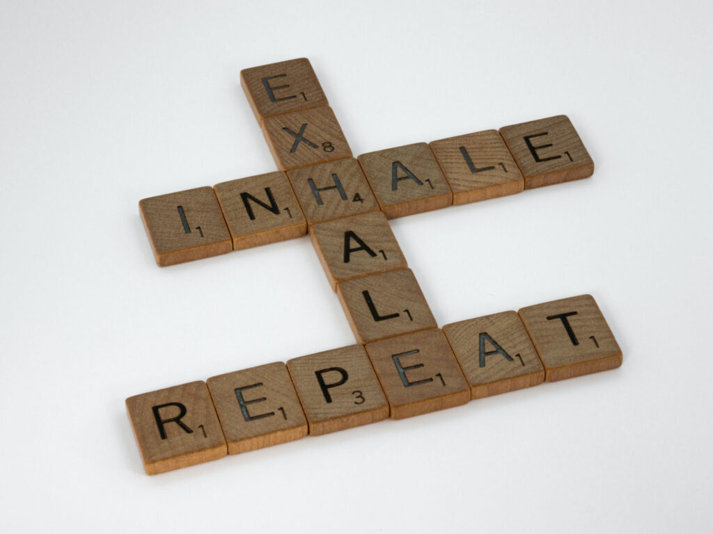 Scrabble board with the words "Inhale", "Exhale", and "Repeat"