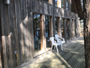a wooden deck with large windows at indralaya, a mindfulness and meditation retreat center in puget sound