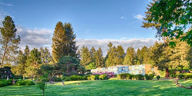 A view of the building and grounds at dumas bay retreat center.