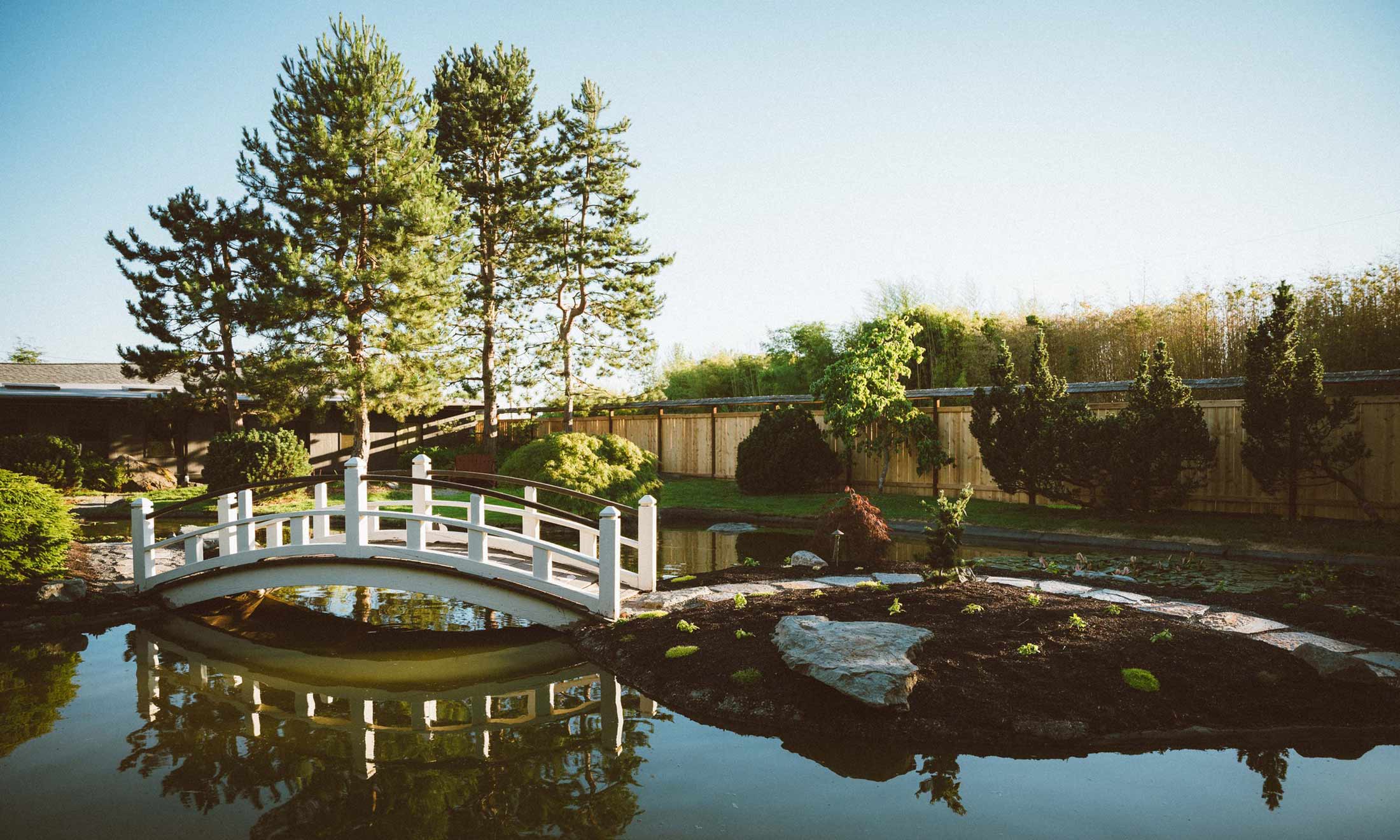 A white bridge over a small pond at Bow Sanctuary, where this event takes place.